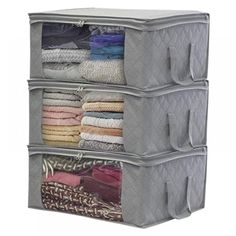 three storage bins are stacked on top of each other with folded clothes in them