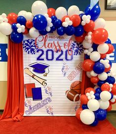 an arch made out of balloons and streamers for a class of 2020 graduation celebration