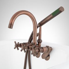 the faucet is connected to two hoses on top of a bathtub