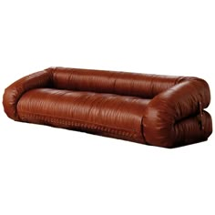 a brown leather couch sitting on top of a white floor