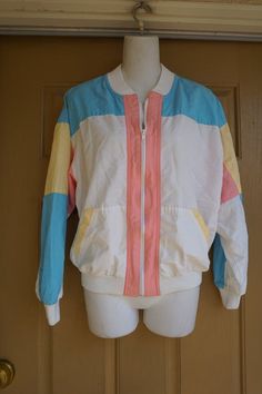 Vintage 90s windbreaker jacket marked size 10. Light weight and great for jogging. In good vintage condition. Measurements taken across front lying flat23" armpit to armpit15" across waist22" length Retro Long Sleeve Windbreaker For Spring, Retro Long Sleeve Spring Windbreaker, 90s Style Multicolor Windbreaker For Spring, Vintage Nylon Windbreaker For Spring, Retro Cotton Windbreaker For Spring, Retro Cotton Track Jacket For Spring, White Vintage Track Jacket For Spring, Color Block Long Sleeve Windbreaker For Spring, Casual Color Block Track Jacket For Spring