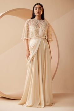 Roqa | Estella Off-White Drape Sari And Cape | INDIASPOPUP.COM Cape Top Outfits, Cape Dress Indian, Drape Sari, Saree Jacket Designs, Cape Dresses, Wedding Guess, Off White Saree, Cutdana Embroidery, Saree Gowns