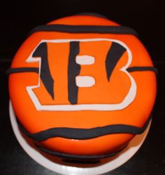 a close up of a cake with the letter b on it's icing