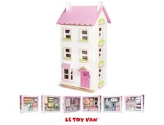 a doll house with pink roof, windows and lots of toys in the box next to it