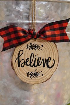 a wooden ornament with the word believe on it