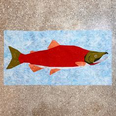 a red fish on a blue and white background