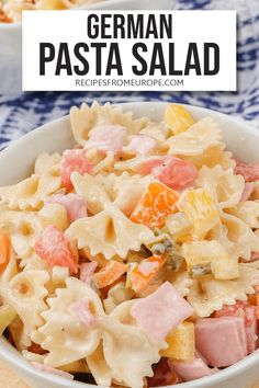 a bowl filled with pasta and ham on top of a table