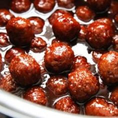 meatballs are being cooked in the oil and then coated with brown sauce, ready to be eaten