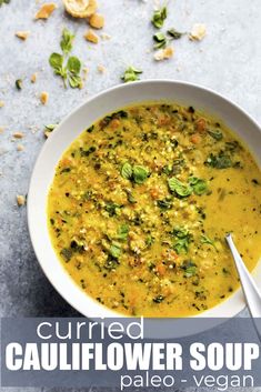 a white bowl filled with cauliflower soup on top of a gray countertop