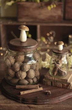 two jars filled with nuts on top of a wooden table