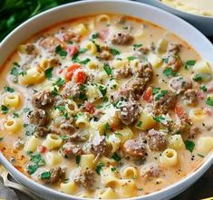 a white bowl filled with pasta and meat soup