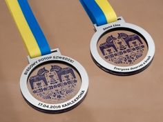 two medals with blue, yellow and white ribbons