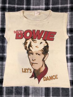 David Bowie - Vintage 1983 - Let's Dance - Classic Pop Rock Star Concert Tour T Shirt - Size S The shirt shows wear and fading. The shirt color is an off white. The shirt has some stains on the front, back, and inside neckline of the shirt. There is a hole and some fraying on the front. The shoulder seam is coming undone slightly. The shirt has pilling. Please refer to the photos Dance Pop, Band Concert, Dream Outfits, Concert T Shirt, Let's Dance, 1980s Fashion, Pop Dance, Lets Dance, Concert Tshirts