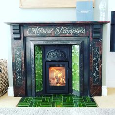 an ornate fireplace with green tiles on the floor and a sign above it that reads altered reppoins