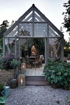 a small greenhouse with lots of plants in it