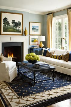 a living room filled with furniture and a fire place in the middle of a room