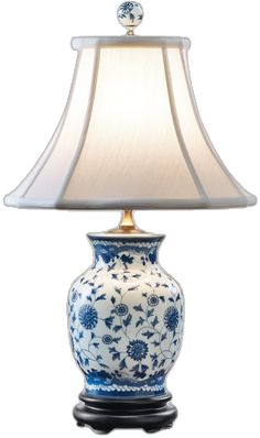 a blue and white vase with a lamp on top