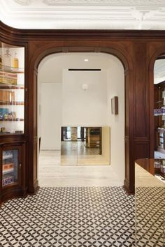 the inside of a store with wooden shelves and glass doors on either side of it