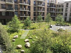 an apartment building with landscaping in the foreground