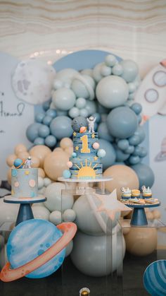 a space themed birthday party with balloons and cake