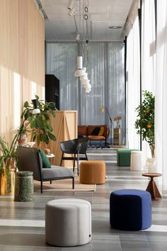 a living room filled with lots of furniture and plants