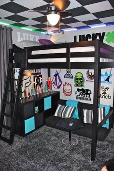 a bunk bed with a desk underneath it and lots of stickers on the wall