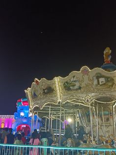 a merry go round at night with people on it