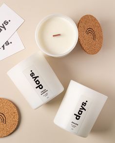 two candles and cork coasters next to each other