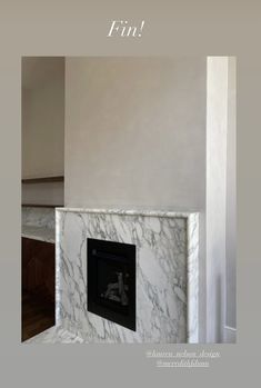 a fireplace with a white marble surround and the words find on it in black lettering