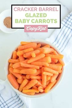 a bowl filled with baby carrots on top of a table