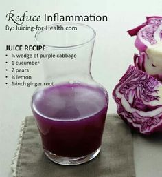 a purple cabbage juice in a glass next to an onion