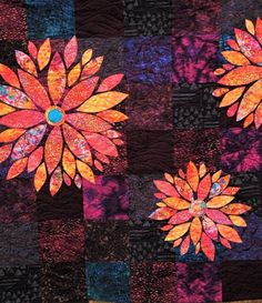 an image of a colorful quilt with flowers in the center and on the bottom side