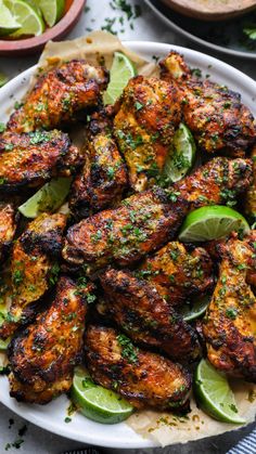 grilled chicken with limes and herbs on a plate