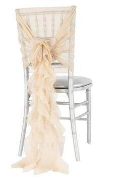 a white chair with a beige ruffled sash on it