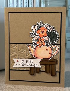 a close up of a card with flowers and a teapot on it's side