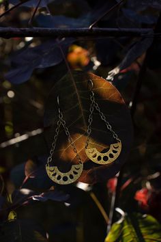 These handcrafted phases of the moon earrings have been inspired into creation by my love for and connection with the moon and her cyclical phases.  Solid raw brass arcs with the phases of the  moon cut out in them dangle from textured solid sterling silver chains and ear hooks.  I can make these earrings with either a regular ear hook or 16g hand hammered hoop ring that works well for stretched ears. See last pictures for stretched ear hoops and examples of the earrings with the stretched hoop Bohemian Crescent Moon Phase Jewelry, Crescent Sun And Moon Festival Jewelry, Festival Crescent Sun And Moon Jewelry, Festival Crescent Jewelry With Sun And Moon Design, Mystical Gold Moon Phase Earrings, Mystical Crescent Brass Earrings, Bohemian Half Moon Nickel-free Jewelry, Nickel-free Half Moon Bohemian Jewelry, Handmade Crescent Brass Jewelry