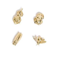 four different types of gold jewelry on a white background