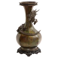 a bronze vase with a dragon on it