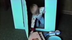 a baby is in the corner of a refrigerator