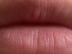 a close up view of someone's lips with pinkish on them and the tip of their lip