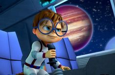 a cartoon boy with glasses sitting in front of a computer screen and holding a microphone