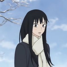 a woman with long black hair and white scarf on her neck standing in front of snow covered trees