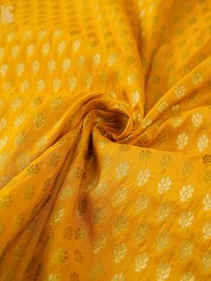 the fabric is yellow with white flowers on it