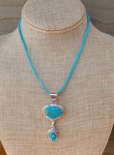 This stunning pendant is show stopper, handcrafted with Sterling Silver and set with Kingman Turquoise. This is truly a high end piece that you will enjoy for a lifetime!NOTE: You will receive the pendant only Measures: 2 1/2" x 1 1/8" (with bale) Weight: 13 grams Stamped: Sterling Signed: L.M.Y. (Larry Yazzie) Southwestern Jewelry With Large Round Pendant, Western Style Turquoise Necklace With Large Pendant As Gift, Western Turquoise Necklace With Large Pendant For Gifts, Southwestern Turquoise Necklace With Large Round Pendant, Large Western Style Pendant Jewelry, Southwestern Style Turquoise Round Pendant Necklace, Western Style Turquoise Pendant Jewelry, Western Turquoise Pendant Necklace, Western Style Turquoise Necklace With Large Pendant