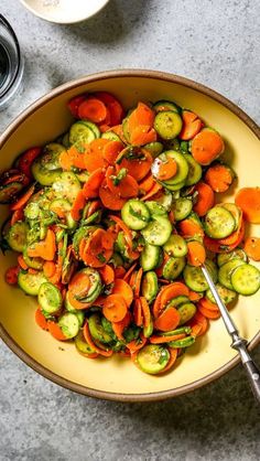 a yellow bowl filled with sliced up veggies