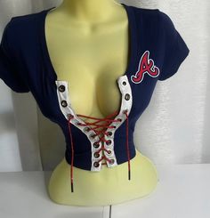 Atlanta Braves Crop Top with red lace. Please note estimated time to ship these items is 7-10 business days as they are made to order. If you need it right away please send us a message and we will try our best to accommodate your request.  Don't see your team? Send us a message with a request and we will gladly accommodate it. Cheap Fan Gear Tops With Lettering, Very Cropped Top, Atlanta Hawks Outfit Women, Diy Lace Up Top, Beyonce Stage Outfits, Risky Outfits, Asymmetrical Top Outfit, Ashanti 2000's, Stage Performance Outfits