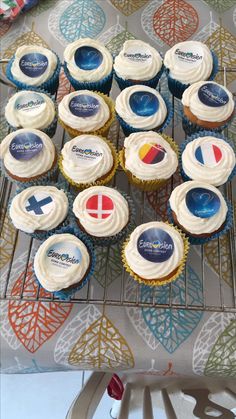 cupcakes with frosting and pepsi logos on them sitting on a cooling rack