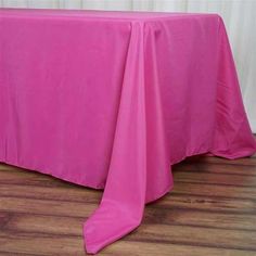 a pink table cloth on top of a wooden floor