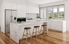 a large kitchen with white cabinets and marble counter tops, two stools at the island