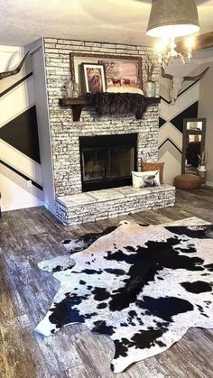 the living room is decorated with cow hide rugs